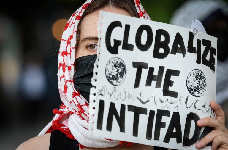 A student protester holds a sign reading "Globalize the Intifada" at Columbia University in New York City - source: Reuters