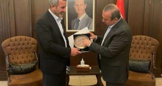 Abu Fadak meeting and receiving an award from Syrian Minister of Local Affairs Hussein Makhlouf
