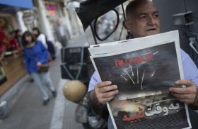 An Iranian man holds a newspaper depicting the April 14 attack on Israel.