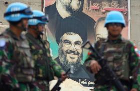 UNIFIL peacekeepers in Lebanon in front of a poster depicting Hezbollah chief Hassan Nasrallah - source: Reuters