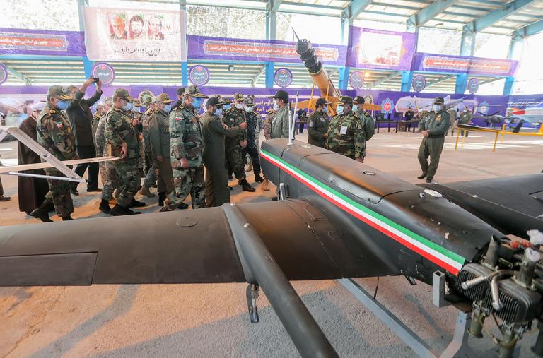 Iranian military leaders inspect drones.