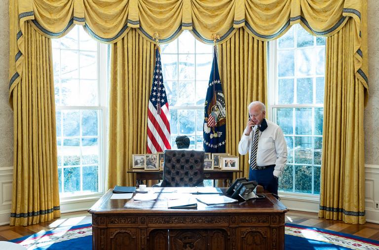 President Joe Biden speaks on the phone in the Oval Office of the White House