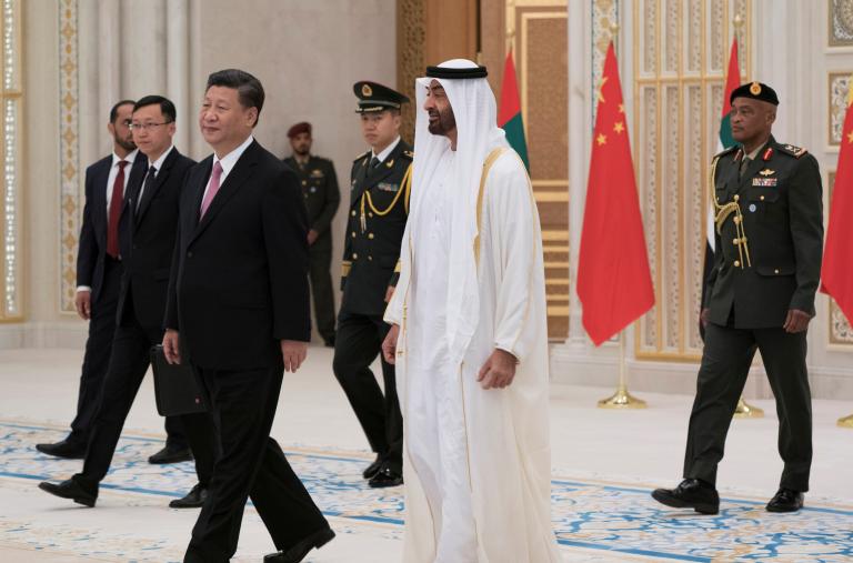 Photo of Chinese and Emirati leaders walking.