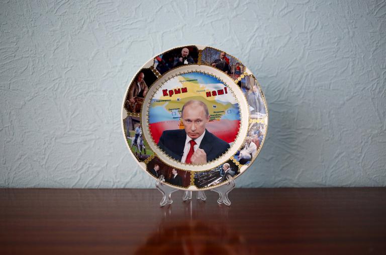 A souvenir plate depicting Russian President Putin and Crimea - source: Reuters