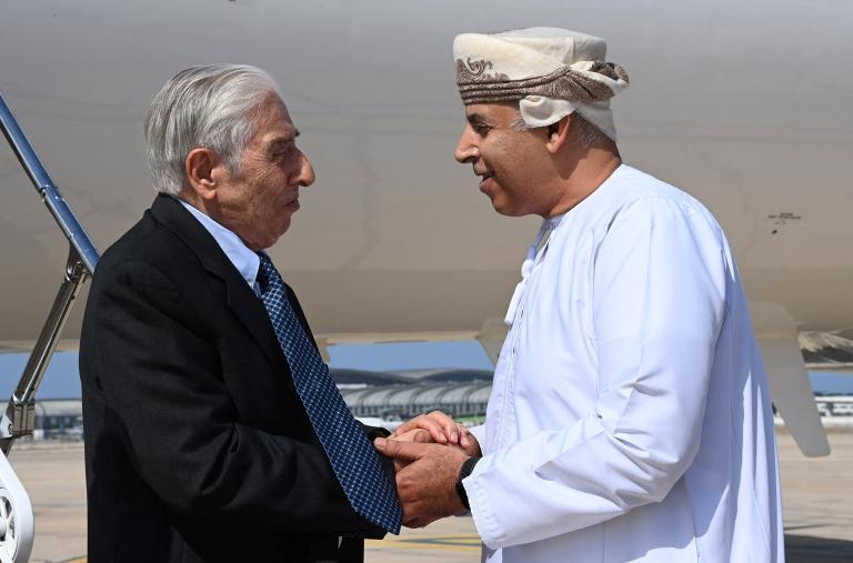 Baquer Namazi, a dual U.S.-Iranian citizen who had been imprisoned in Iran, shakes hands with an Omani official in Muscat - source: Reuters