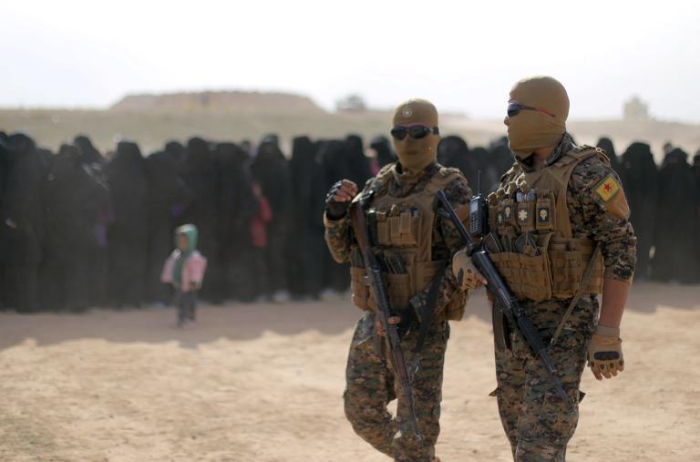 Fighters of Syrian Democratic Forces (SDF), walk together near Baghouz, Deir Al Zor province - source: Reuters