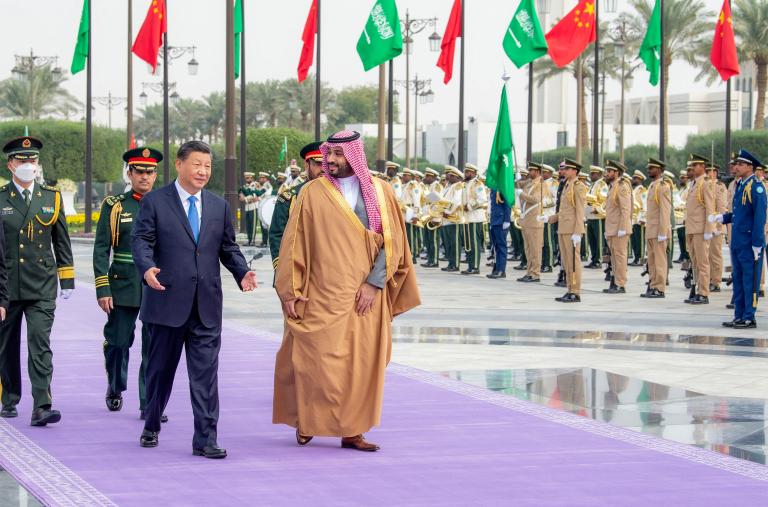 Crown Prince Muhammad and President Xi walking in Riyadh.