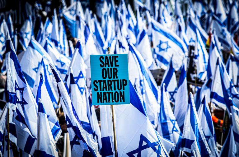Protesters wave flags and placards in front of the Knesset to demonstrate their opposition to judicial reforms proposed by the coalition government of Israeli Prime Minister Netanyahu - source: Reuters