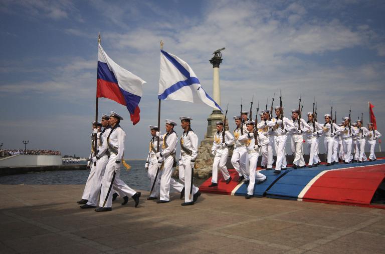 Russian sailors parade with their national and Navy flags in the port of Sevastopol in occupied Crimea - source: Reuters