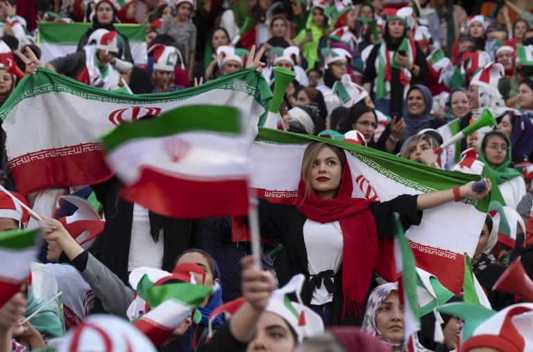 Iranian women display their national flag at a soccer game - source: Reuters