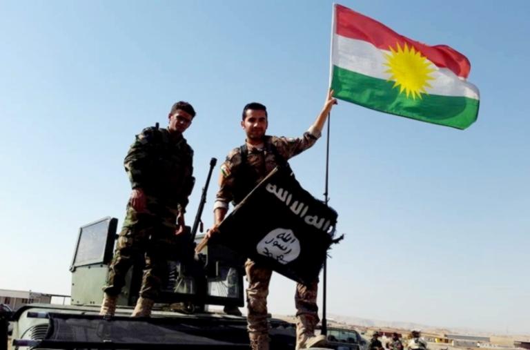 Peshmerga fighters throwing away ISIS flag