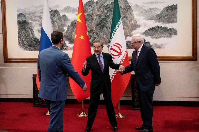 Chinese Foreign Minister Wang Yi greets Russian Deputy Foreign Minister Sergey Ryabkov and Iranian Deputy Foreign Minister Kazem Gharibabadi in Beijing in March 2025 - source: Reuters