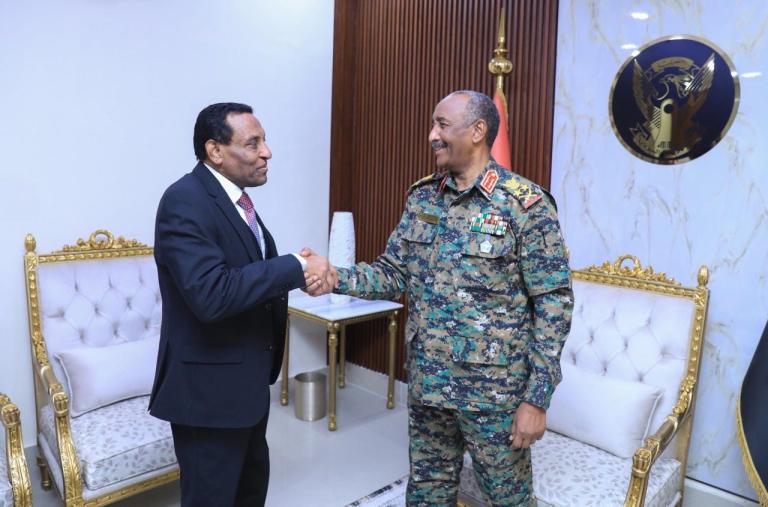 Burhan and Idris shake hands