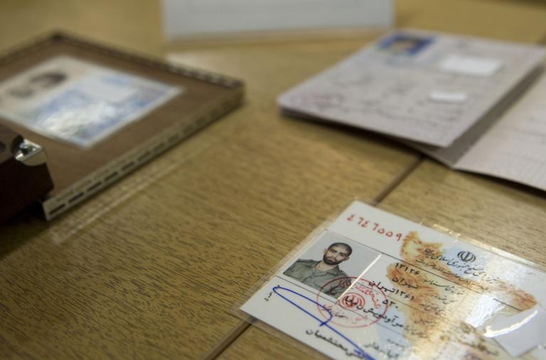 Iranian officials display what they claim to be counterfeit identification documents seized from accused spies - source: Reuters