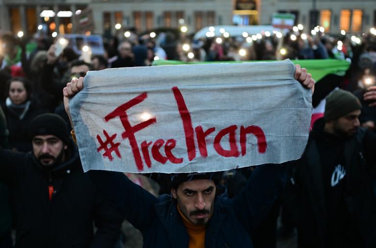 A protester holds a #FreeIran banner in Berlin - source: Reuters