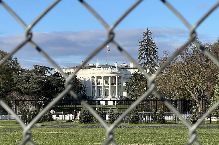 The White House photographed from behind a chain-link fence - source: Reuters