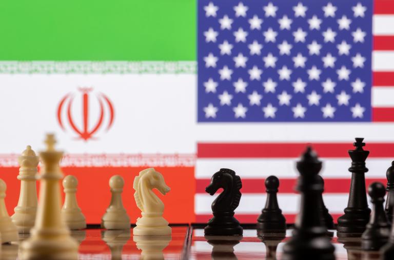 A photo illustration depicts chess pieces and the Iranian and U.S. flags - source: Reuters