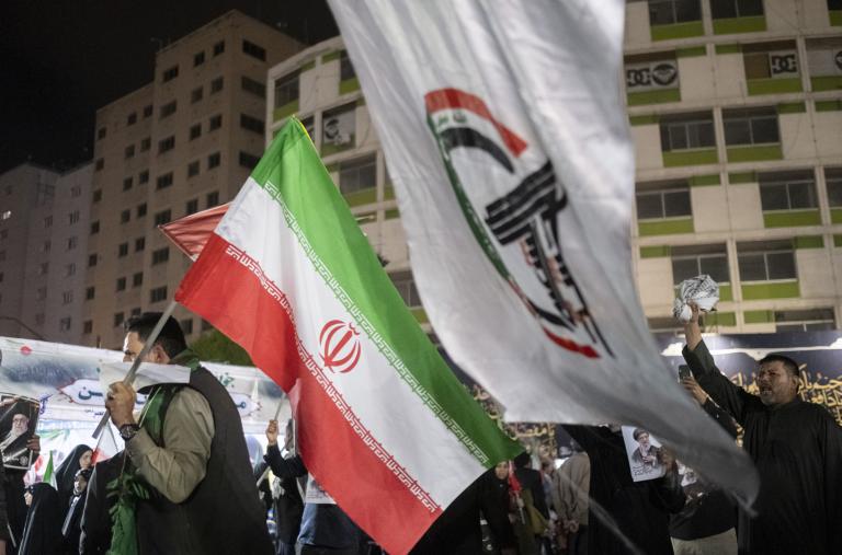 Iraqi protesters display Iranian and Popular Mobilization Forces militia flags at a demonstration in Baghdad following the killing of Iranian Supreme Leader Khamenei - source: Reuters