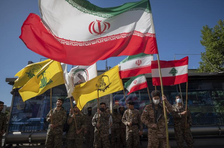 Flags of Iran, Hezbollah, and Lebanon are seen at a Quds Day celebration in Tehran - source: Reuters