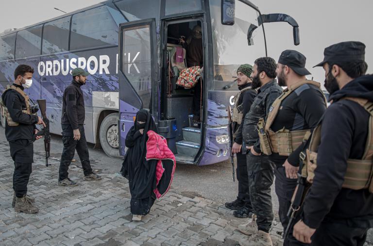 Photo of a girl being transferred from a camp for Islamic-State-affiliated detainees in Syria.
