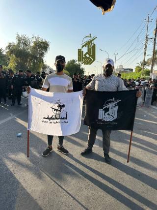 Ashab al-Kahf and Iraqi Basij flags raised together near the U.S. embassy in Baghdad on July 14, 2023. 