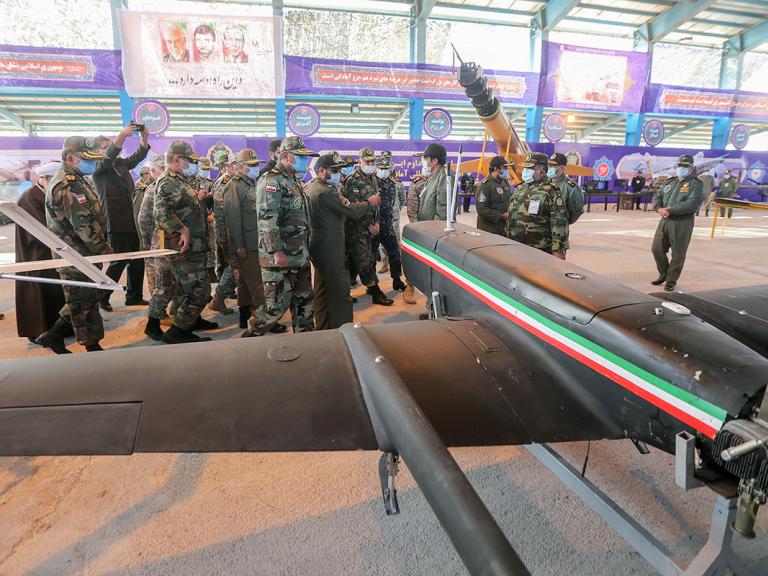 Iranian military leaders inspect drones.