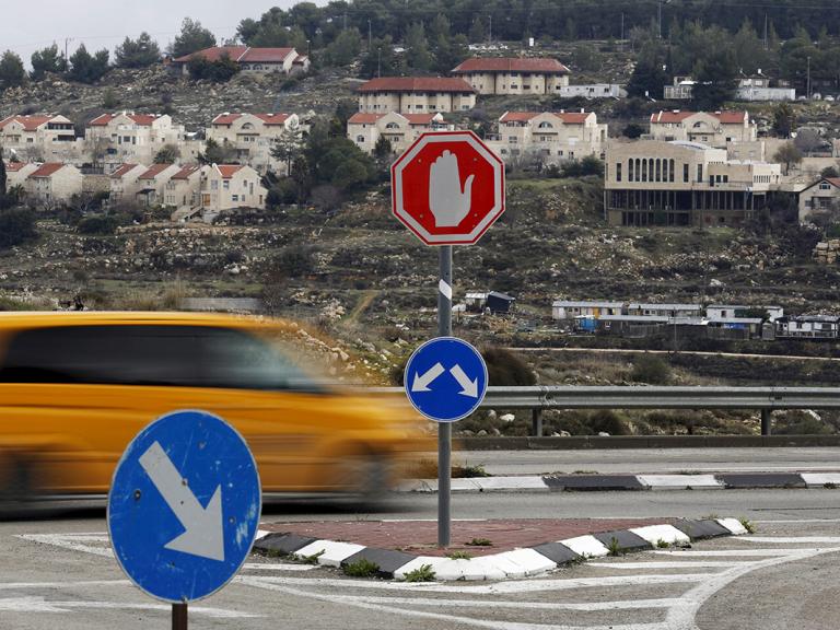 Traffic passes the Israeli settlement of Efrat in the West Bank