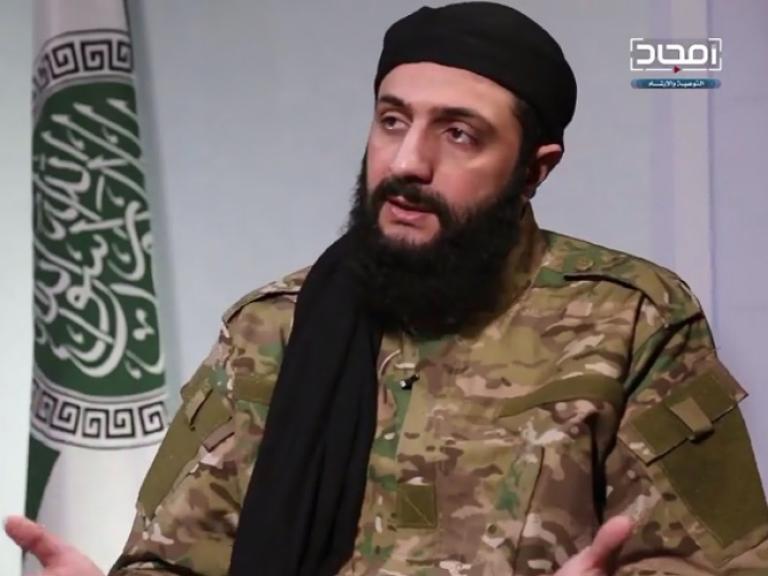 Abu Muhammad al-Jawlani, leader of Hayat Tahrir al-Sham, speaks in a recorded interview released in Jan. 2019. Photo credit: Screenshot by Cole Bunzel via Twitter.