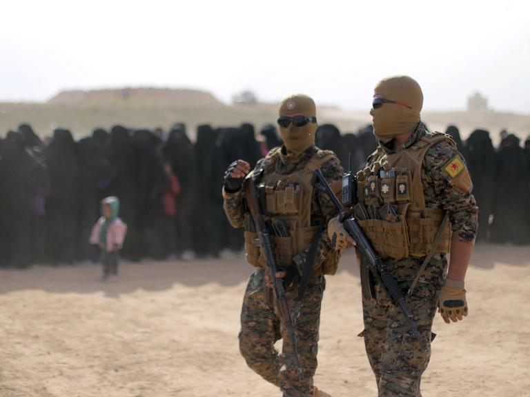 Fighters of Syrian Democratic Forces (SDF), walk together near Baghouz, Deir Al Zor province - source: Reuters