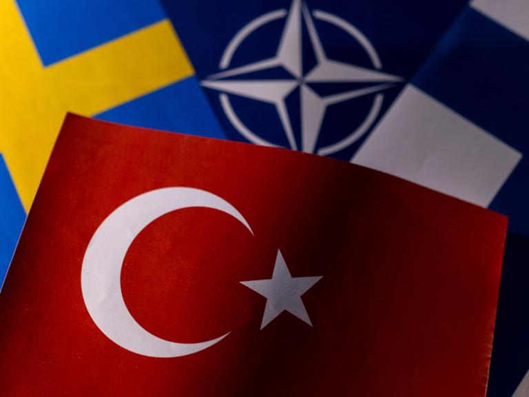 Photo illustration of the flags of Sweden, NATO, Finland, and Turkey - source: Reuters