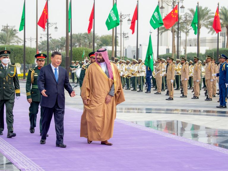 Crown Prince Muhammad and President Xi walking in Riyadh.