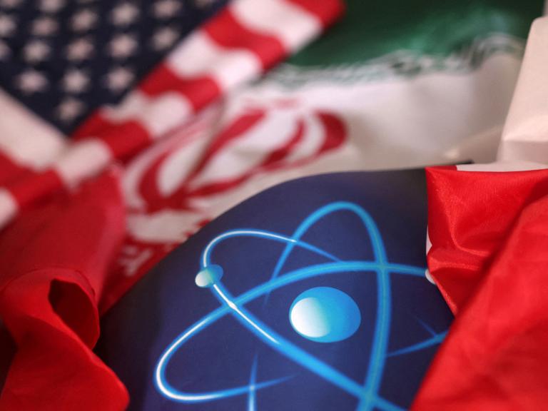 A photo illustration shows US and Iranian flags and an atomic symbol - source: Reuters