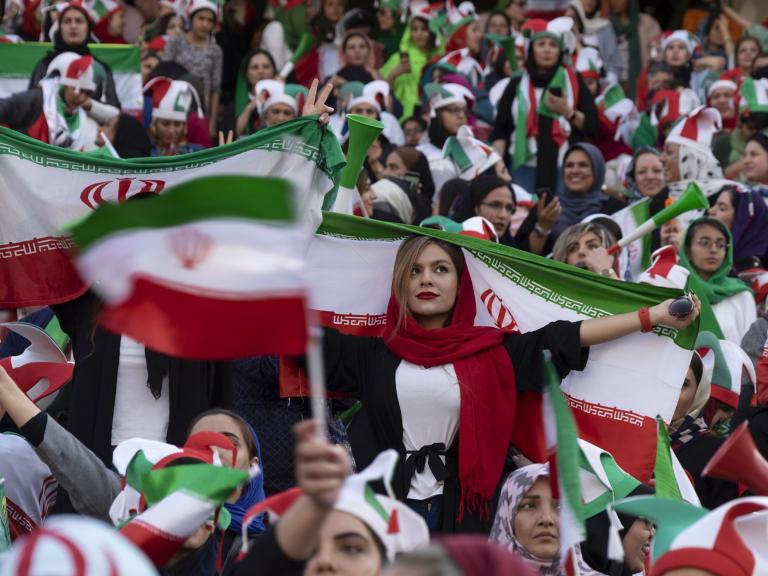 Iranian women display their national flag at a soccer game - source: Reuters