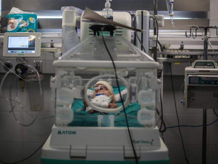 Photo of a Palestinian infant receiving care at a Gaza hospital.