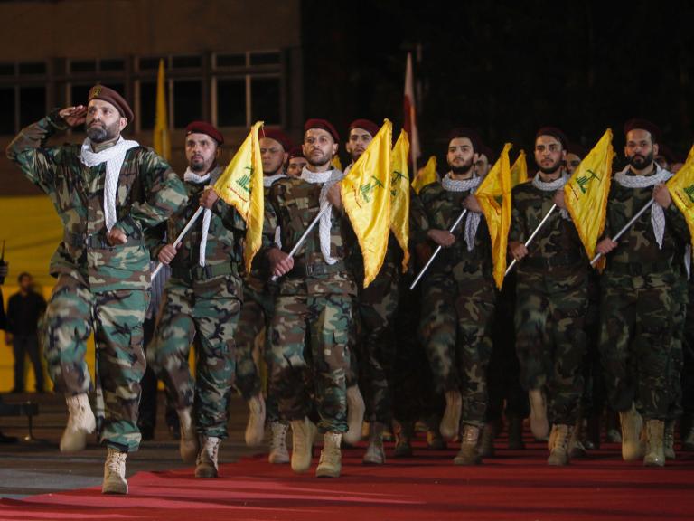Hezbollah fighters parade with flags in Lebanon in 2019 - source: Reuters
