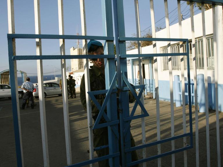 An Israeli border guard secures the gate at a crossing with Lebanon in 2007 - source: Reuters