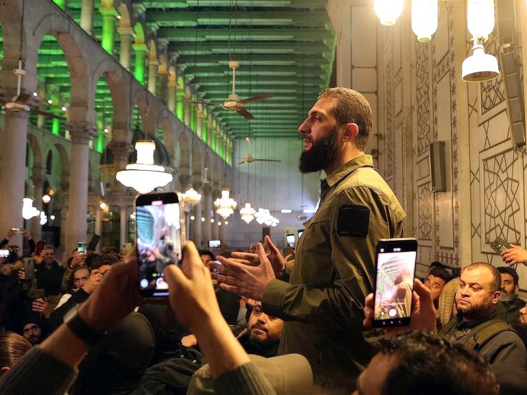 Hayat Tahrir al-Sham chief Abu Mohammed al-Jolani speaks to reporters in Damascus in December 2024 - source: Reuters
