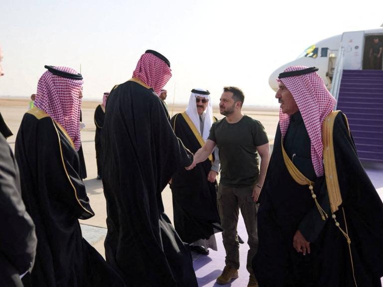 Photo showing Ukraine's President Zelensky greeting Saudi officials on the tarmac. 