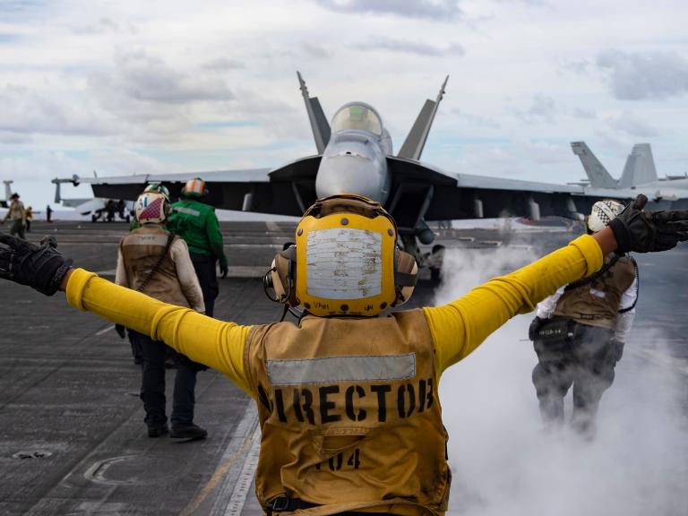 Flight deck crew issues commands to a U.S. Navy F/A-18 Super Hornet prior to launch from the carrier USS Harry S. Truman - source: Department of Defense