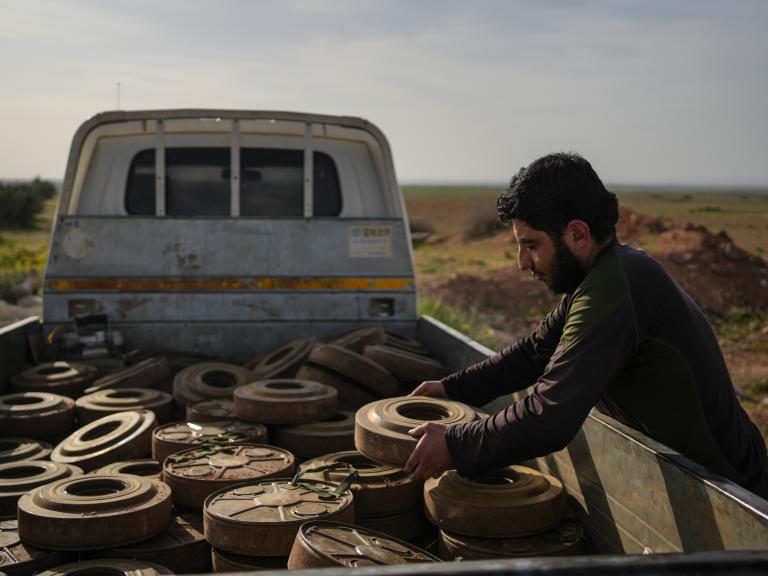 Photo of a Syrian soldier clearing landmines in Idlib province.