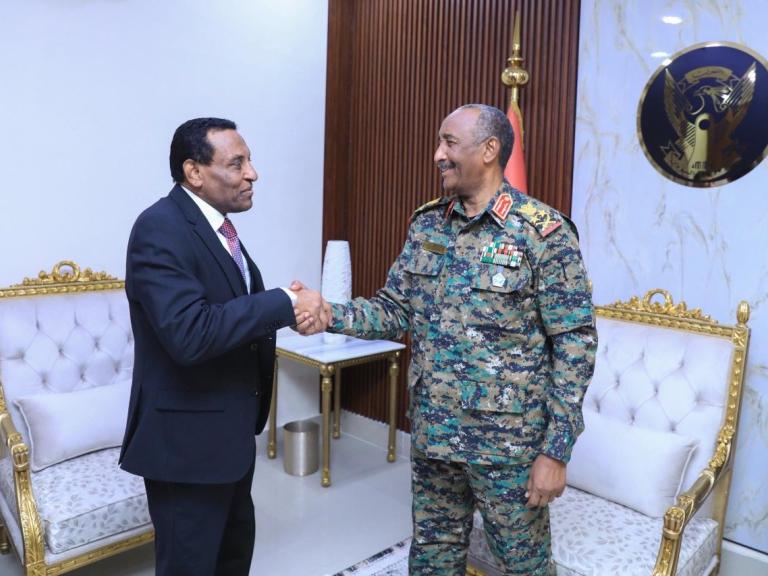 Burhan and Idris shake hands