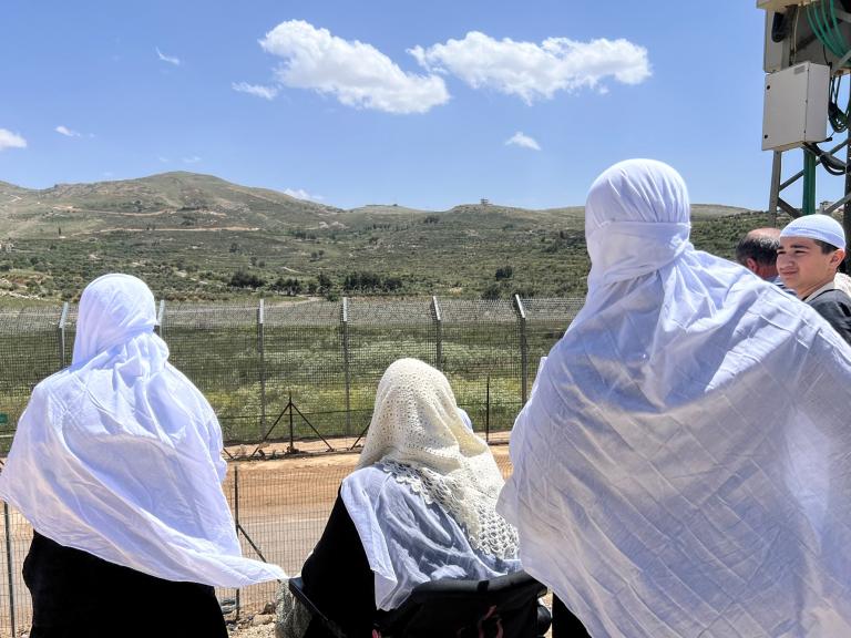 Syrian Druze women look across the Golan border into Israel - source: Reuters