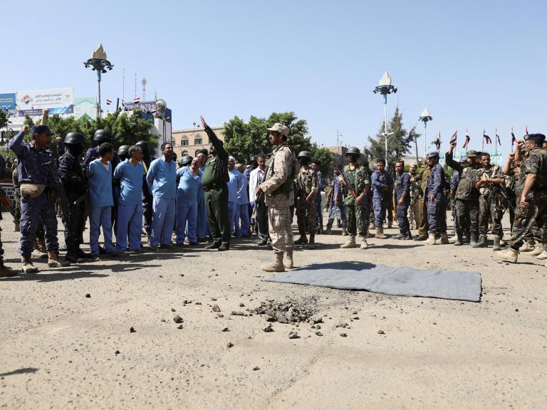 Soldiers stand guard next to men convicted of involvement in the 2018 killing of top Houthi leader Saleh al-Samad before their execution at Tahrir Square in Sanaa, Yemen in September 2021 - source: Reuters