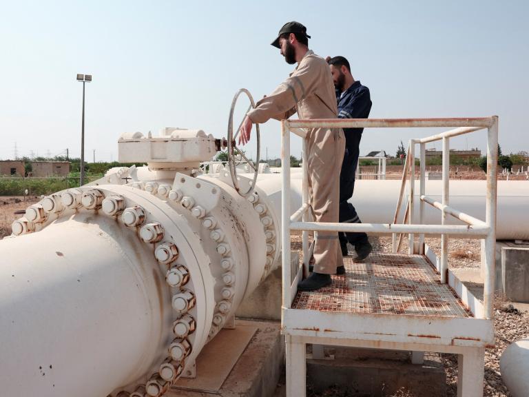 Photo of workers at a natural gas pipeline in Syria.