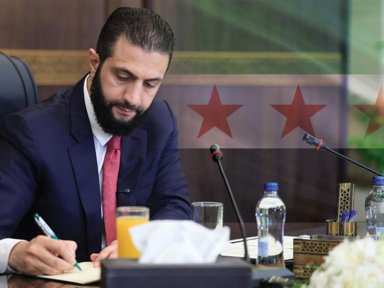 Syrian President Ahmed al-Sharaa places his signature at a cabinet meeting in Damascus, October 12, 2025.