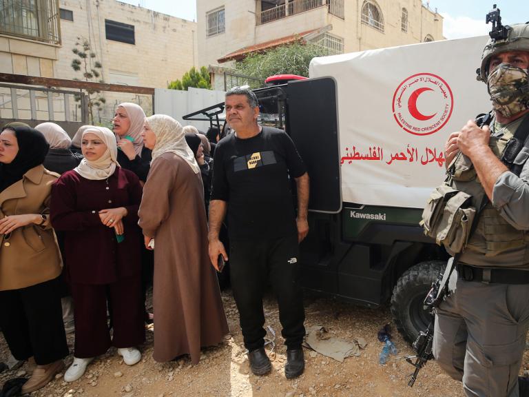 Palestinain refugees wait for IDF permission to gather their belongings while benig expelled from a camp near Jenin - source: Reuters