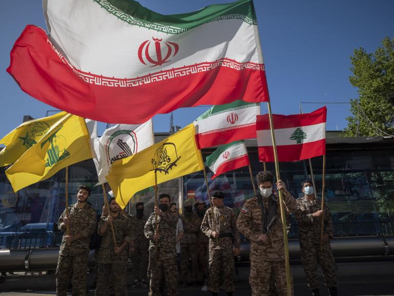 Flags of Iran, Hezbollah, and Lebanon are seen at a Quds Day celebration in Tehran - source: Reuters