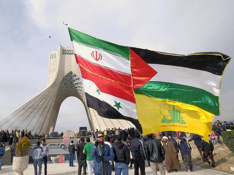 Protesters display Iranian, Syrian, Palestinian, and Hezbollah flags - source: Reuters