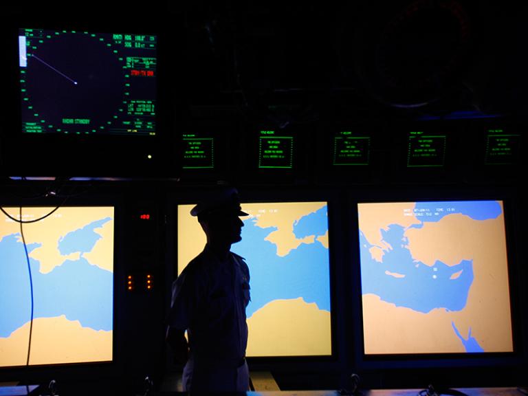 A US Navy sailor stands in front of a map display of the Mediterranean Sea - source: Reuters
