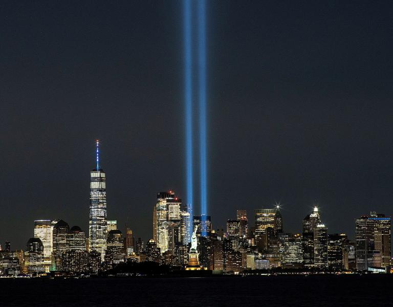 A view of the Memorial In Light display and the Manhattan skyline, beyond the Statue of Liberty - source: Reuters